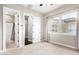 Bright bedroom with carpet flooring, ensuite bathroom and large windows at 1175 E Copper Holw, Queen Creek, AZ 85140
