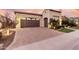 Single-story home with a two-car garage and attractive landscaping at 1175 E Copper Holw, Queen Creek, AZ 85140