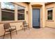 Cozy front porch with two black metal chairs at 1175 E Copper Holw, Queen Creek, AZ 85140