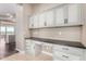 Built-in office space with white cabinets and dark countertop at 1175 E Copper Holw, Queen Creek, AZ 85140