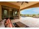 Covered patio with comfortable seating overlooking the pool at 1175 E Copper Holw, Queen Creek, AZ 85140