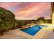 Inviting rectangular pool with a waterfall feature in the backyard at 1175 E Copper Holw, Queen Creek, AZ 85140