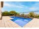 Relaxing rectangular pool, stone feature, and expansive patio at 1175 E Copper Holw, Queen Creek, AZ 85140