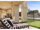 Relaxing backyard patio with covered seating and luxurious lounge chairs at 1233 E Salado Cir, Mesa, AZ 85203