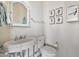 Small bathroom with white pedestal sink, toilet, and framed art at 1233 E Salado Cir, Mesa, AZ 85203