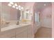 Elegant bathroom with white vanity, tile flooring and a large mirror at 1233 E Salado Cir, Mesa, AZ 85203