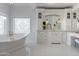 Elegant bathroom with freestanding tub, white hexagonal tile, and gold fixtures at 1233 E Salado Cir, Mesa, AZ 85203
