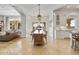 Open dining area with a large wood table and access to the kitchen and backyard at 1233 E Salado Cir, Mesa, AZ 85203