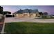 Driveway, basketball court, and home's exterior at dusk at 1233 E Salado Cir, Mesa, AZ 85203