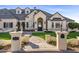 Grand home entrance with a stone walkway and landscaping at 1233 E Salado Cir, Mesa, AZ 85203