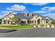 Beautiful single-story home featuring an arched entryway, lush landscaping, and a pristine lawn at 1233 E Salado Cir, Mesa, AZ 85203