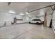 Finished garage with ample space, overhead storage, and a vehicle at 1233 E Salado Cir, Mesa, AZ 85203