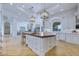 Open kitchen boasts a large island, white cabinets, and a view to the living area at 1233 E Salado Cir, Mesa, AZ 85203