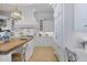 Bright kitchen with white cabinets, wood countertops, and a breakfast bar at 1233 E Salado Cir, Mesa, AZ 85203