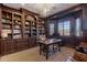 Elegant library with built-in bookshelves and a large desk at 1233 E Salado Cir, Mesa, AZ 85203