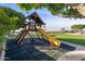 Wooden playset with slide and tire swing at 1233 E Salado Cir, Mesa, AZ 85203