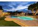Stunning pool with a spa and a waterslide at dusk at 1233 E Salado Cir, Mesa, AZ 85203