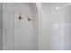 Modern shower with white hexagonal tile and gold fixtures at 1233 E Salado Cir, Mesa, AZ 85203
