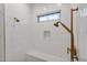 Spa-like shower with white hexagonal tile and gold fixtures at 1233 E Salado Cir, Mesa, AZ 85203