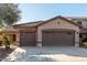 House exterior featuring a two-car garage and desert landscaping at 12821 W Whitton Ave, Avondale, AZ 85392