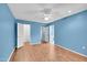 Bright bedroom with wood floors and ceiling fan at 13227 N 110Th Ave, Sun City, AZ 85351