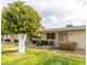 Charming single-story home with a well-manicured lawn and mature, vibrant trees at 13227 N 110Th Ave, Sun City, AZ 85351