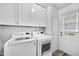 Laundry room with white cabinets and washer and dryer at 13227 N 110Th Ave, Sun City, AZ 85351