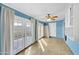 Sunroom with light blue walls, tile floor, and access to a patio at 13227 N 110Th Ave, Sun City, AZ 85351
