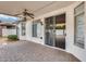 Brick paved patio with sliding glass doors and ceiling fan at 13778 W Cambridge Ave, Goodyear, AZ 85395