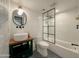 Modern bathroom with white subway tile and black-framed shower at 1425 E Desert Cove Ave # 24, Phoenix, AZ 85020