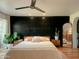 Main bedroom with a dark accent wall and large mirror at 1425 E Desert Cove Ave # 24, Phoenix, AZ 85020