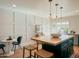 Modern kitchen features a large island with seating, white walls, and dark green cabinetry at 1425 E Desert Cove Ave # 24, Phoenix, AZ 85020