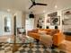 Living room with orange couch and mid-century modern decor at 1425 E Desert Cove Ave # 24, Phoenix, AZ 85020