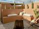 Inviting outdoor patio seating area featuring modern benches, cozy pillows, and desert landscaping with cacti at 1425 E Desert Cove Ave # 24, Phoenix, AZ 85020