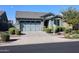 Single-story home with two-car garage and landscaped front yard at 14348 W Aster Dr, Surprise, AZ 85379