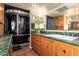 Bathroom with walk-in shower, green marble countertops, and dark wood vanity at 15240 N 51St St, Scottsdale, AZ 85254