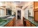 Bathroom with marble counters, terracotta floor and large mirrors overlooking a walk-in closet at 15240 N 51St St, Scottsdale, AZ 85254