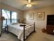 Cozy bedroom with a ceiling fan, carpet, window with blinds, and tasteful wall art at 15240 N 51St St, Scottsdale, AZ 85254