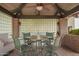 Covered outdoor dining area with seating for four and garden views at 15240 N 51St St, Scottsdale, AZ 85254