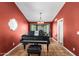 Elegant dining room with a grand piano, terracotta floors, and tasteful decor at 15240 N 51St St, Scottsdale, AZ 85254