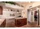 Kitchen island with marble countertop, travertine floors, and open to living area at 15240 N 51St St, Scottsdale, AZ 85254