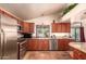 Well-equipped kitchen featuring stainless steel appliances, granite countertops, and ample cabinet space for storage at 15240 N 51St St, Scottsdale, AZ 85254