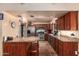 Cherry wood cabinets with granite countertops, stainless steel appliances, and travertine flooring at 15240 N 51St St, Scottsdale, AZ 85254