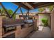Outdoor kitchen area with built-in grill, counter space and patio area at 15240 N 51St St, Scottsdale, AZ 85254