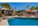 Outdoor pool area with covered patio and lounge chairs under a bright, sunny sky at 15240 N 51St St, Scottsdale, AZ 85254