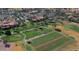 Aerial view of community golf course, clubhouse, and driving range at 16713 W Monterey Way, Goodyear, AZ 85395