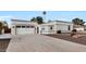 Single-story home with a two-car garage and desert landscaping at 16832 N Pine Valley Dr, Sun City, AZ 85351