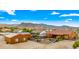 Aerial view of a house with a pool and large backyard, mountain views in the background at 19711 W Georgia Ave, Litchfield Park, AZ 85340