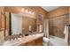 Clean bathroom with double vanity and a shower/tub combo at 19711 W Georgia Ave, Litchfield Park, AZ 85340