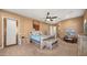 Bright and spacious bedroom with a wooden bed frame and carpeted floors at 19711 W Georgia Ave, Litchfield Park, AZ 85340